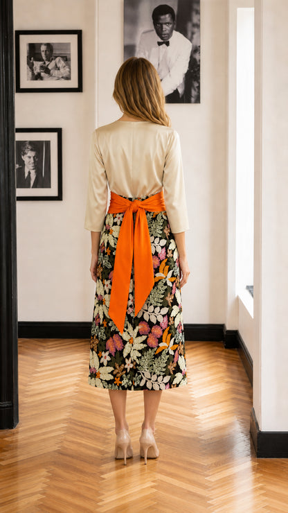 Back view of model showing bow detail on orange waist sash