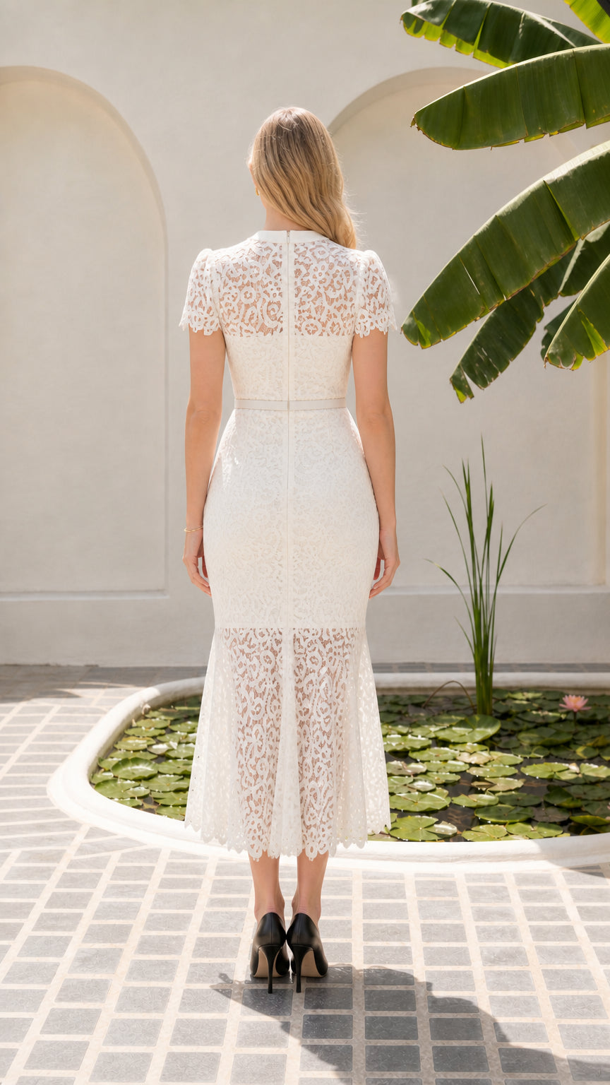 Back view of model in white lace midi dress featuring concealed zipper closure