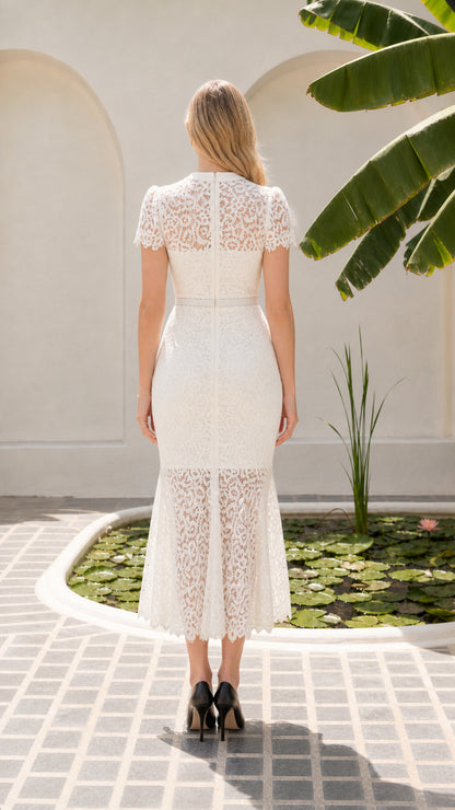 Back view of model in white lace midi dress featuring concealed zipper closure