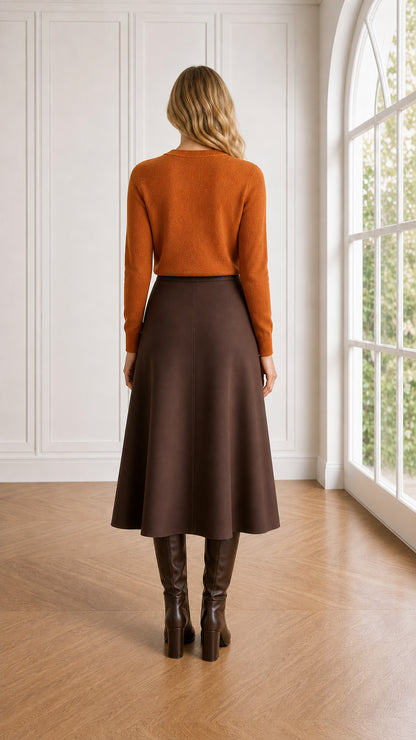 Back view of model wearing rust crewneck pullover sweater with midi skirt