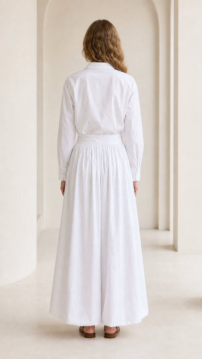 Woman wearing white matching set, back view