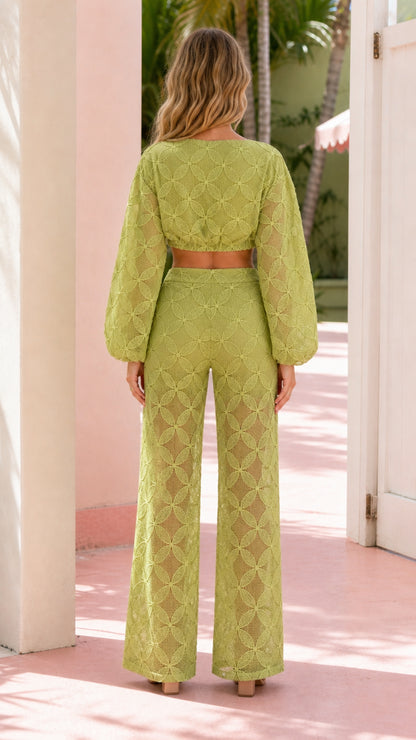 Back view of model in sage green crop top and wide-leg pants