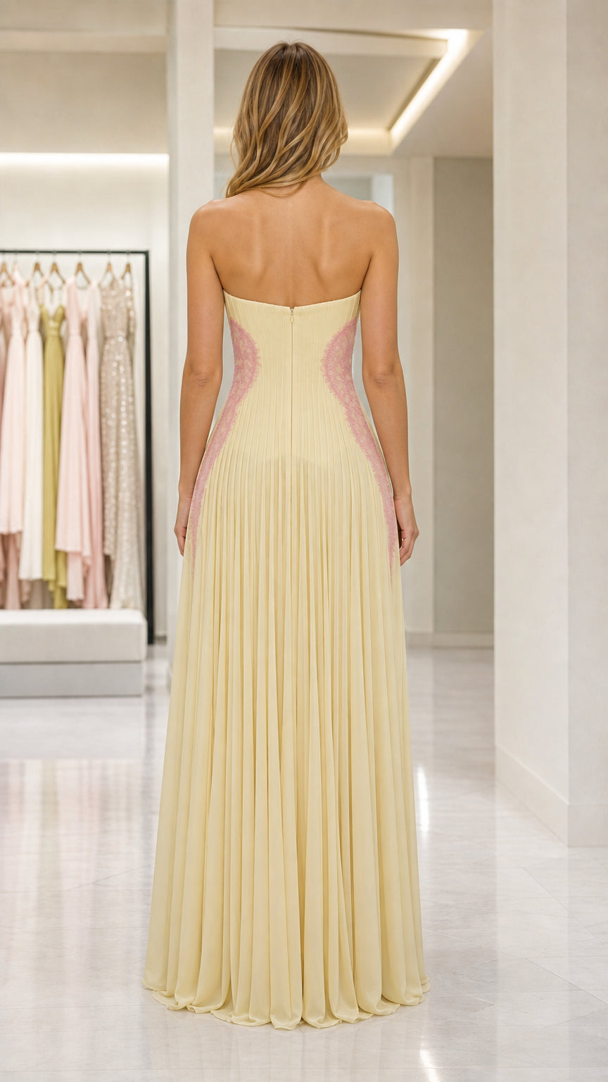 Back view of yellow strapless pleated evening gown