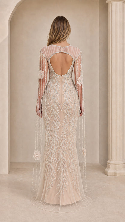 Back view of champagne gown showing open back cutout and long beaded cape