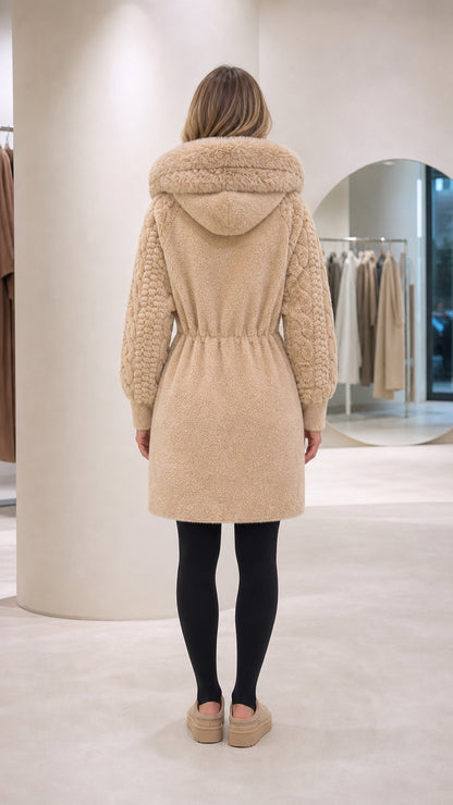 Back view of woman wearing beige hooded mid-length fleece coat