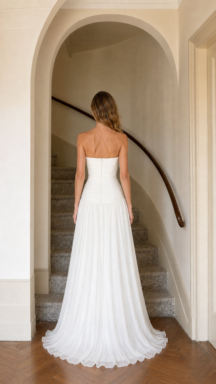 Back view of strapless white chiffon maxi dress showing sleek back silhouette