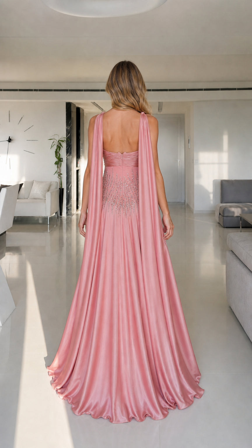 Model wearing pink satin maxi dress back view with draped straps