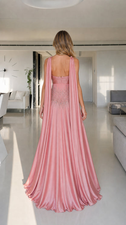 Model wearing pink satin maxi dress back view with draped straps