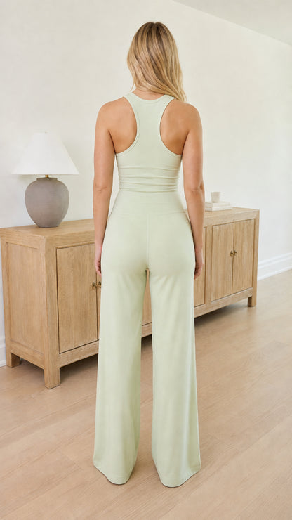 Back view of Sage Green jumpsuit showing racerback detail and wide pant leg