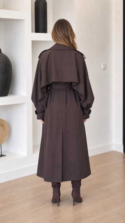 Dark brown women's midi trench coat shown from the back with cape yoke and belted waist