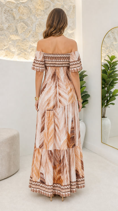 Back view of woman wearing beige off-shoulder maxi dress