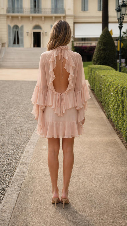 Back view showing open back design of blush pink dress