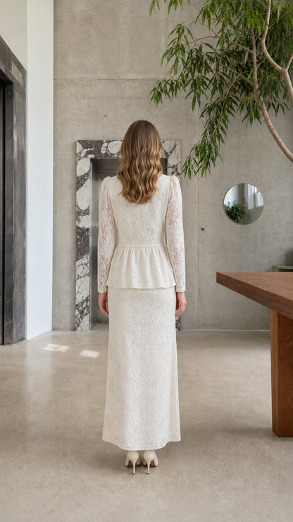 Back view of model wearing the Cream lace peplum top and matching floor-length skirt