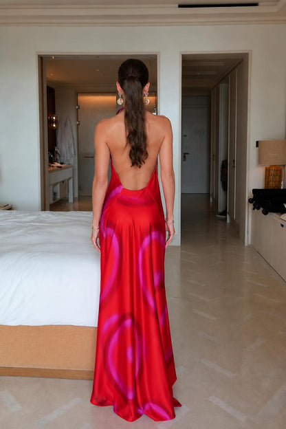 Model wearing red tie-dye satin halter maxi dress back view