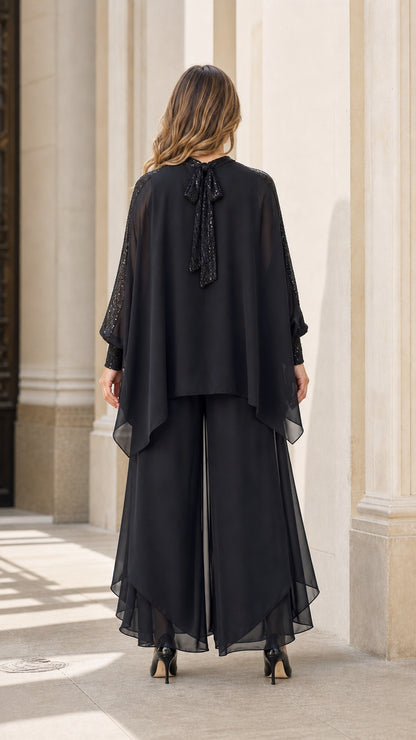 Model wearing black evening set, back view showing tie detail