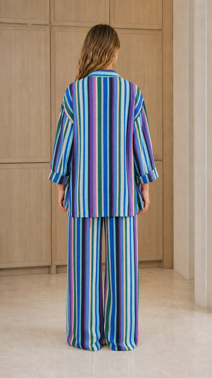Back view of woman wearing blue multi striped two-piece set