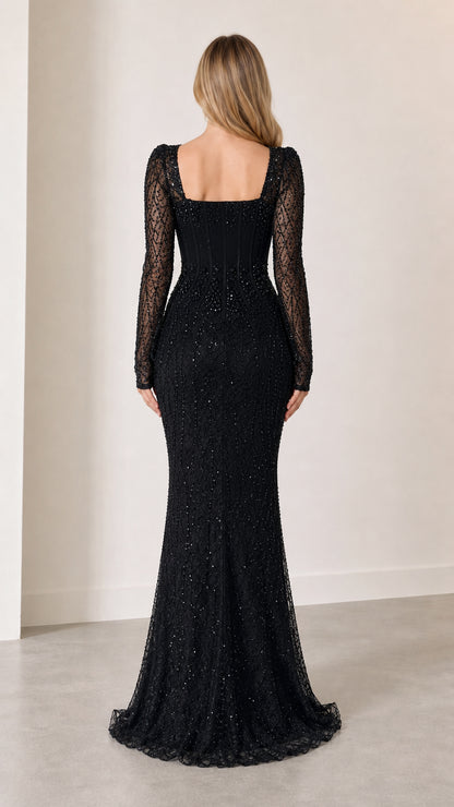 Back view of model in black long sleeve beaded evening dress with square back