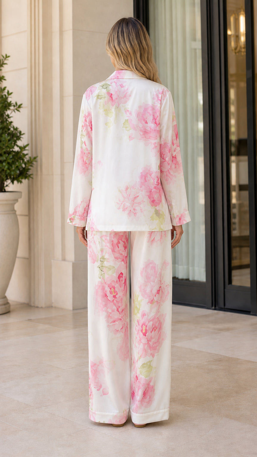 Back view of model wearing ivory floral print two-piece pajama set