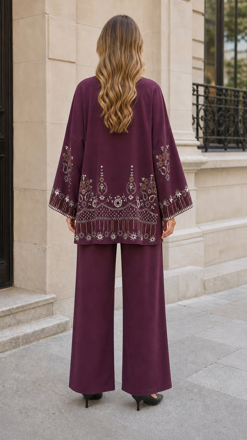 Back view of plum cardigan showing detailed embroidery on hemline and sleeves