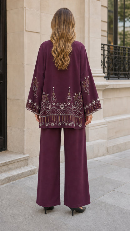 Back view of plum cardigan showing detailed embroidery on hemline and sleeves