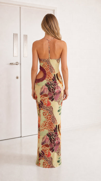 Back view of woman showing open back detail of yellow maxi dress