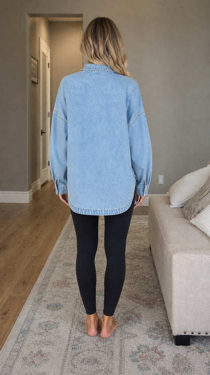 Back view of woman showing curved hemline of light blue denim shacket