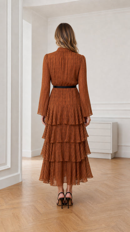 Back view of model in the rust brown long sleeve mock neck tiered maxi dress