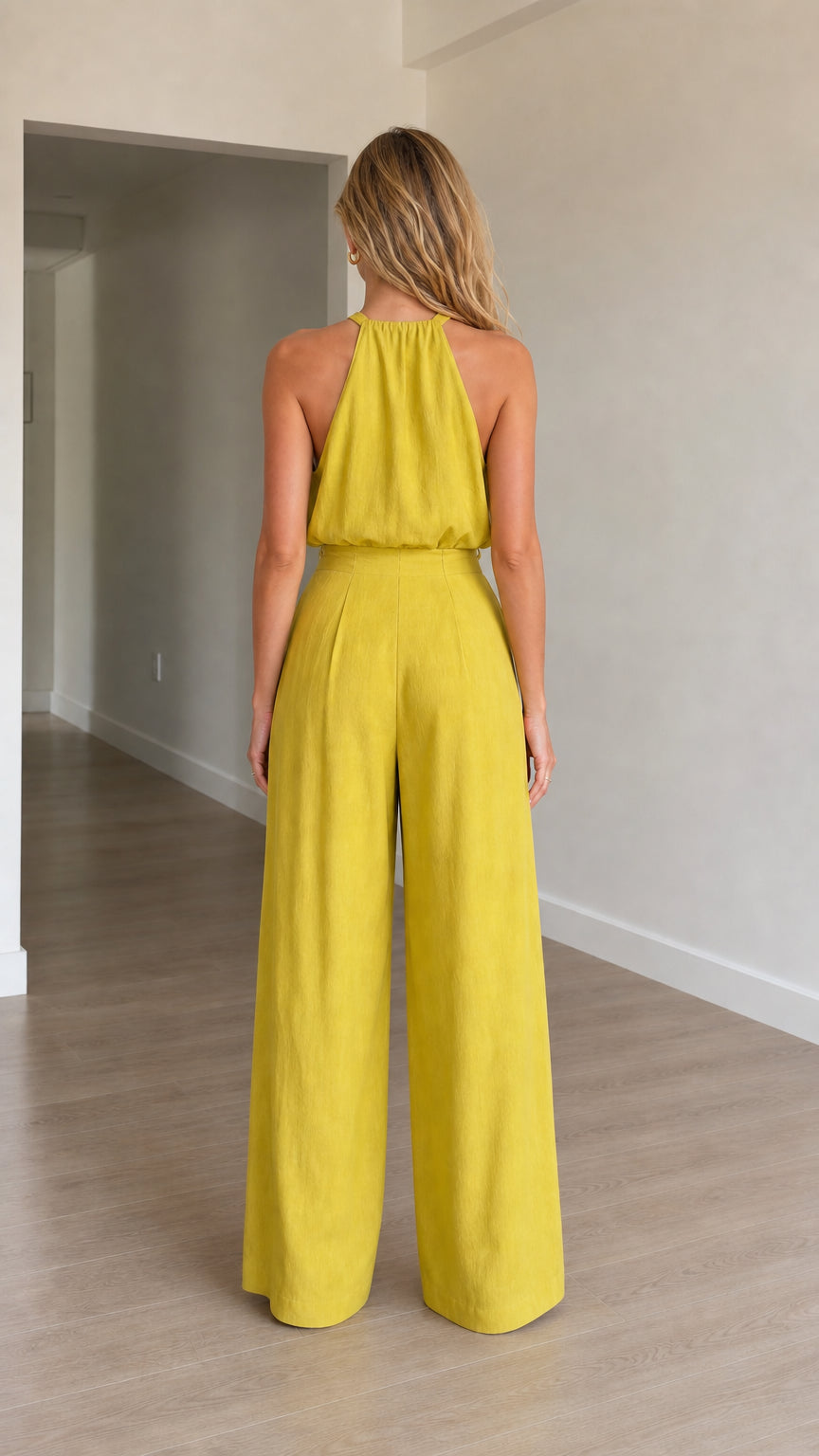 Model wearing yellow jumpsuit back view