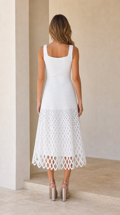 Back view of woman wearing white midi dress showing square back