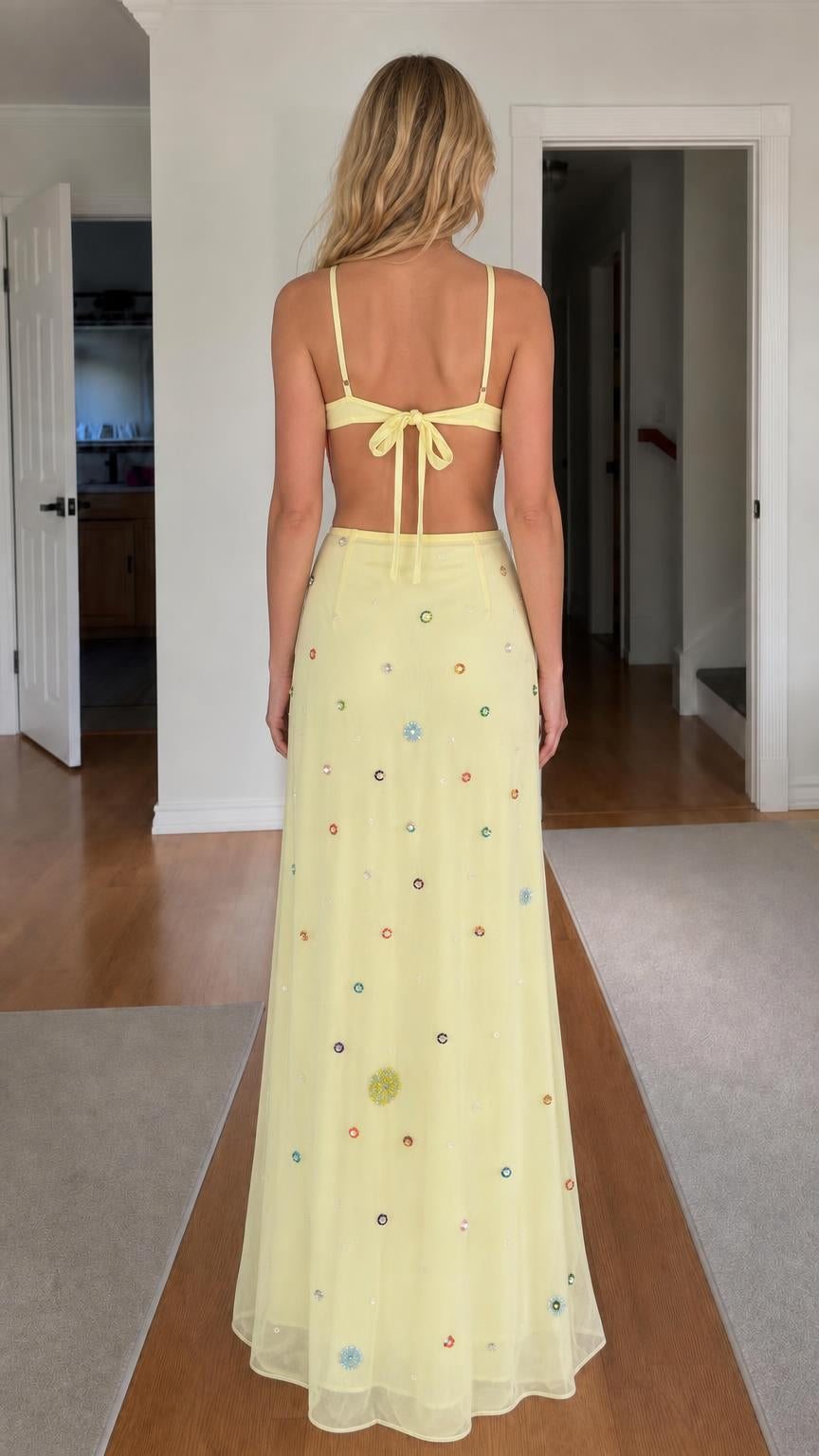 Back view of model showing open-back tie detail on yellow dress