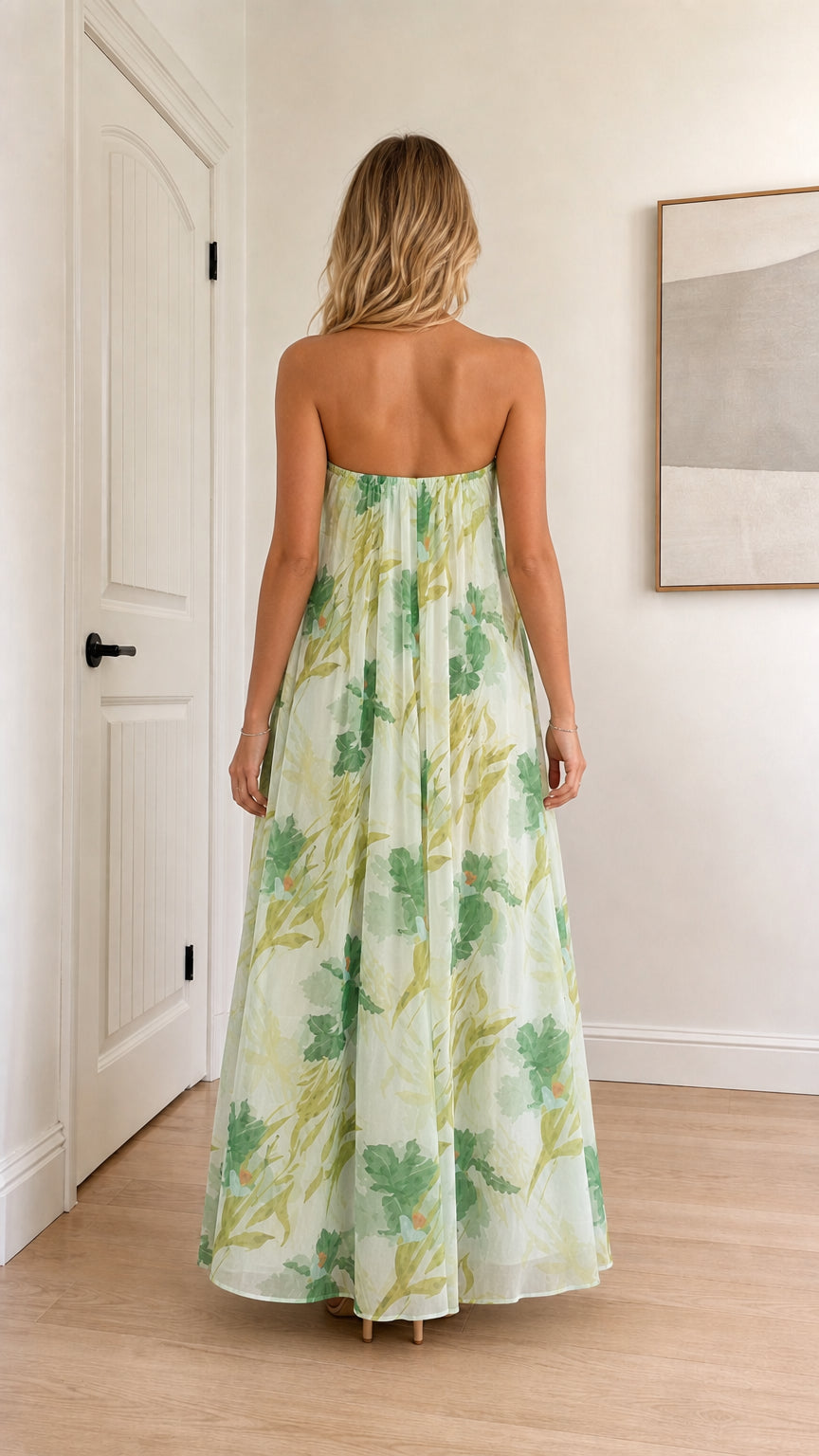 Model wearing sage green floral strapless maxi dress back view