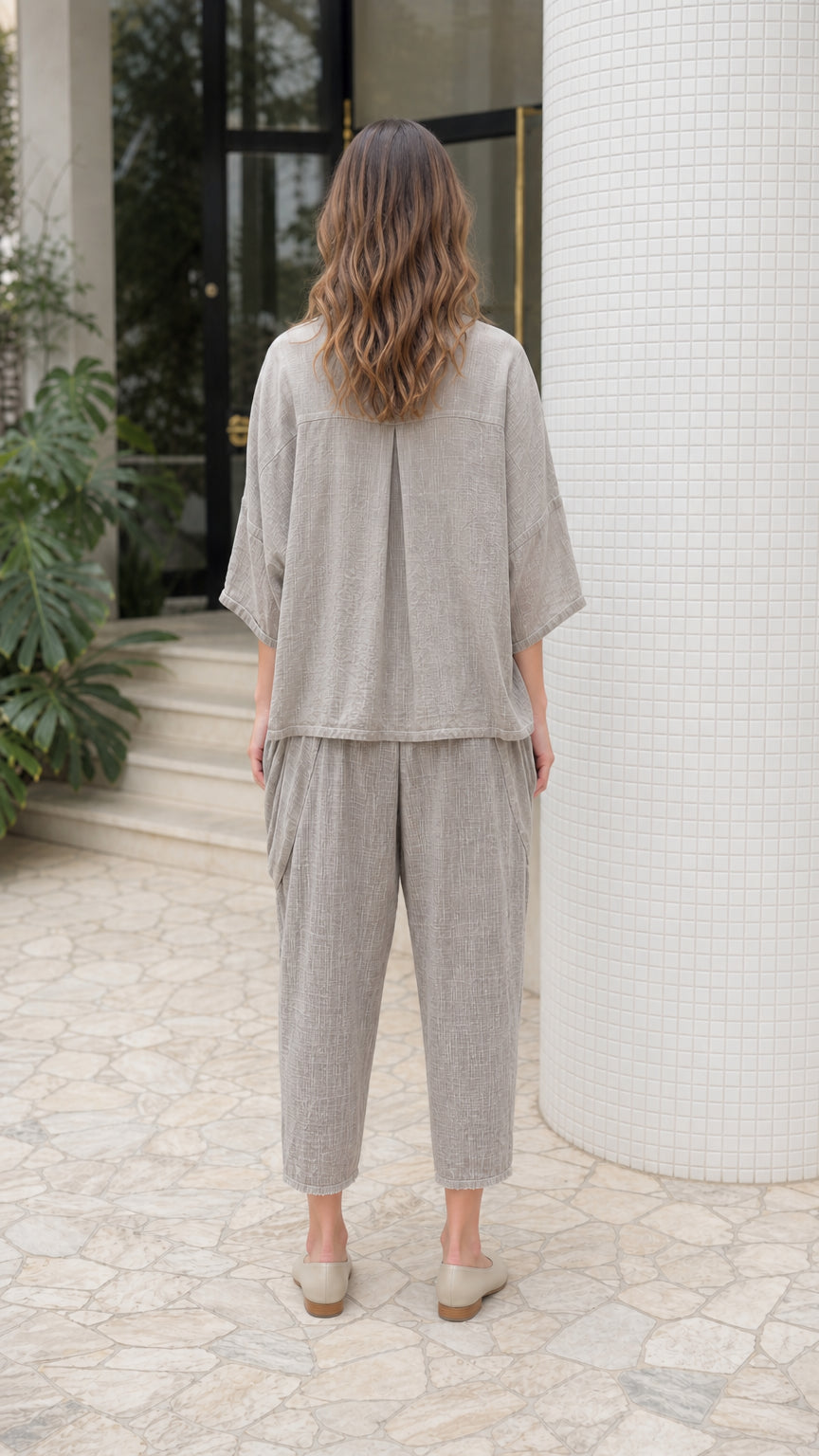 Back view of woman wearing grey lounge set showing relaxed fit and back pleat detail