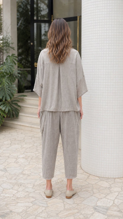 Back view of woman wearing grey lounge set showing relaxed fit and back pleat detail