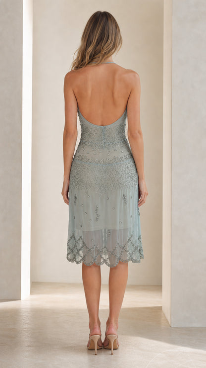 Back view showing open-back design of the sage green dress