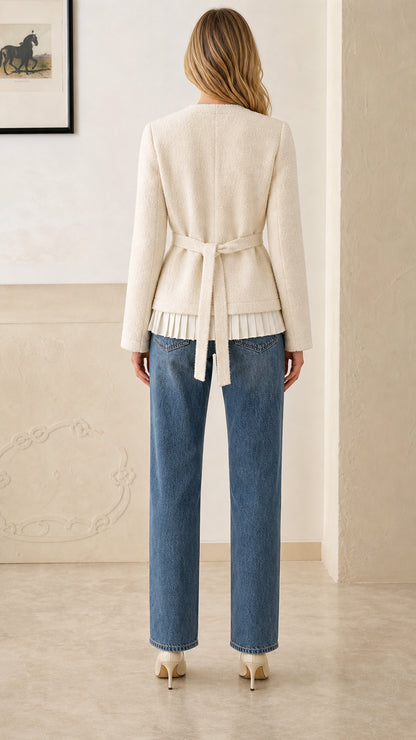 Back view of cream tweed jacket showing adjustable waist tie sash and pleated hem