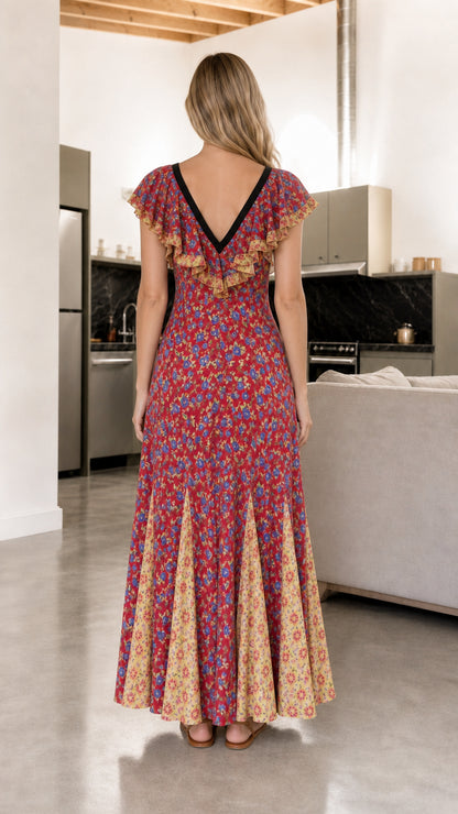 Back view of woman showing deep V-back and ruffle detailing on red floral maxi dress