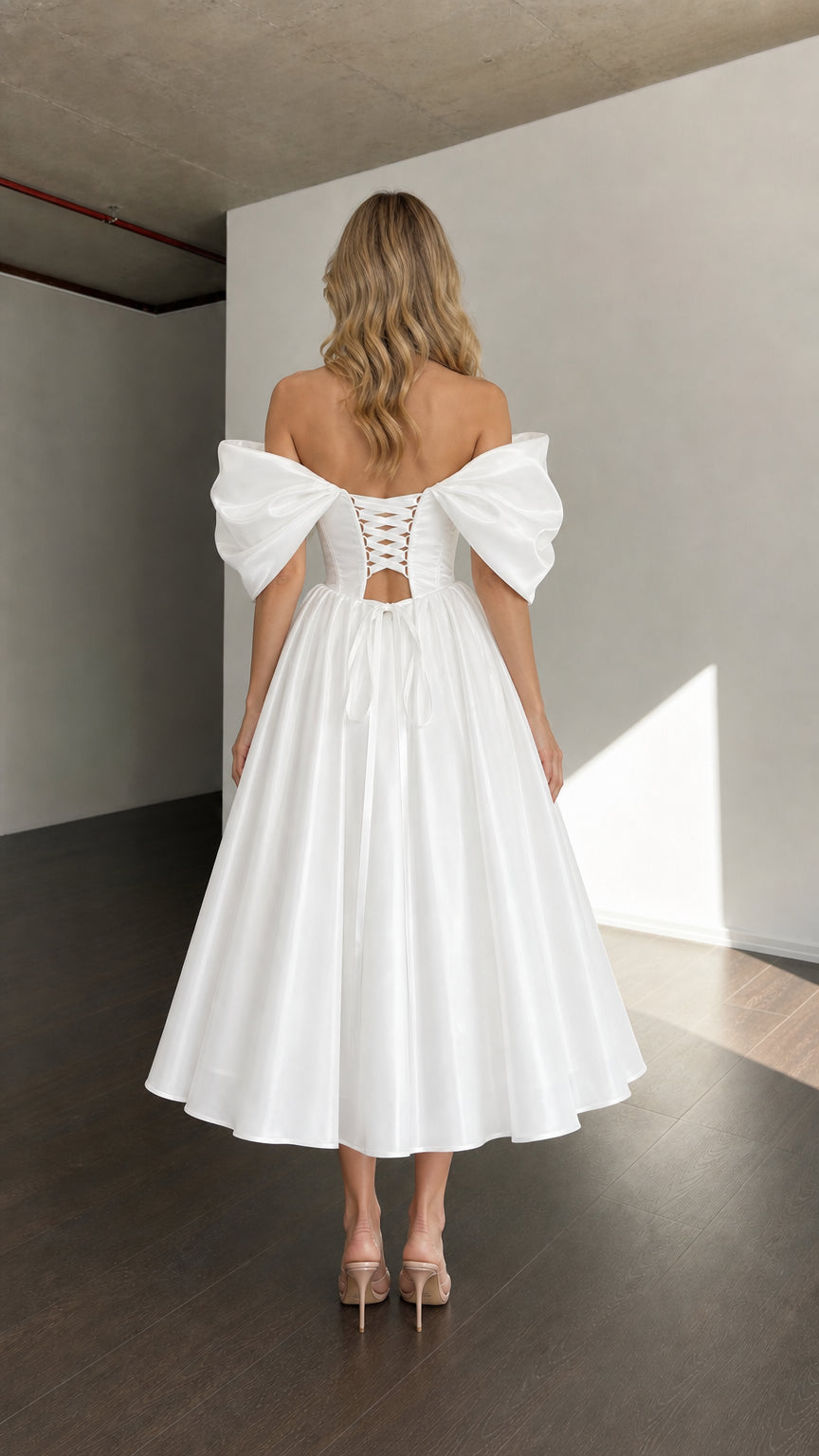 Back view of woman wearing white dress showing lace-up corset detail