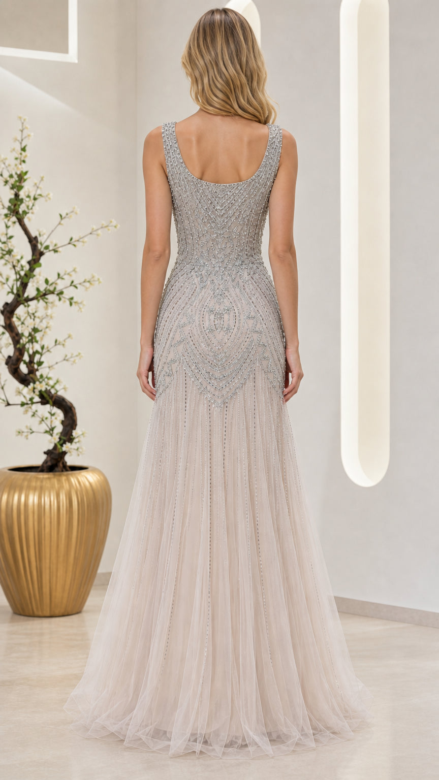 Back view of champagne floor-length gown highlighting scoop back design
