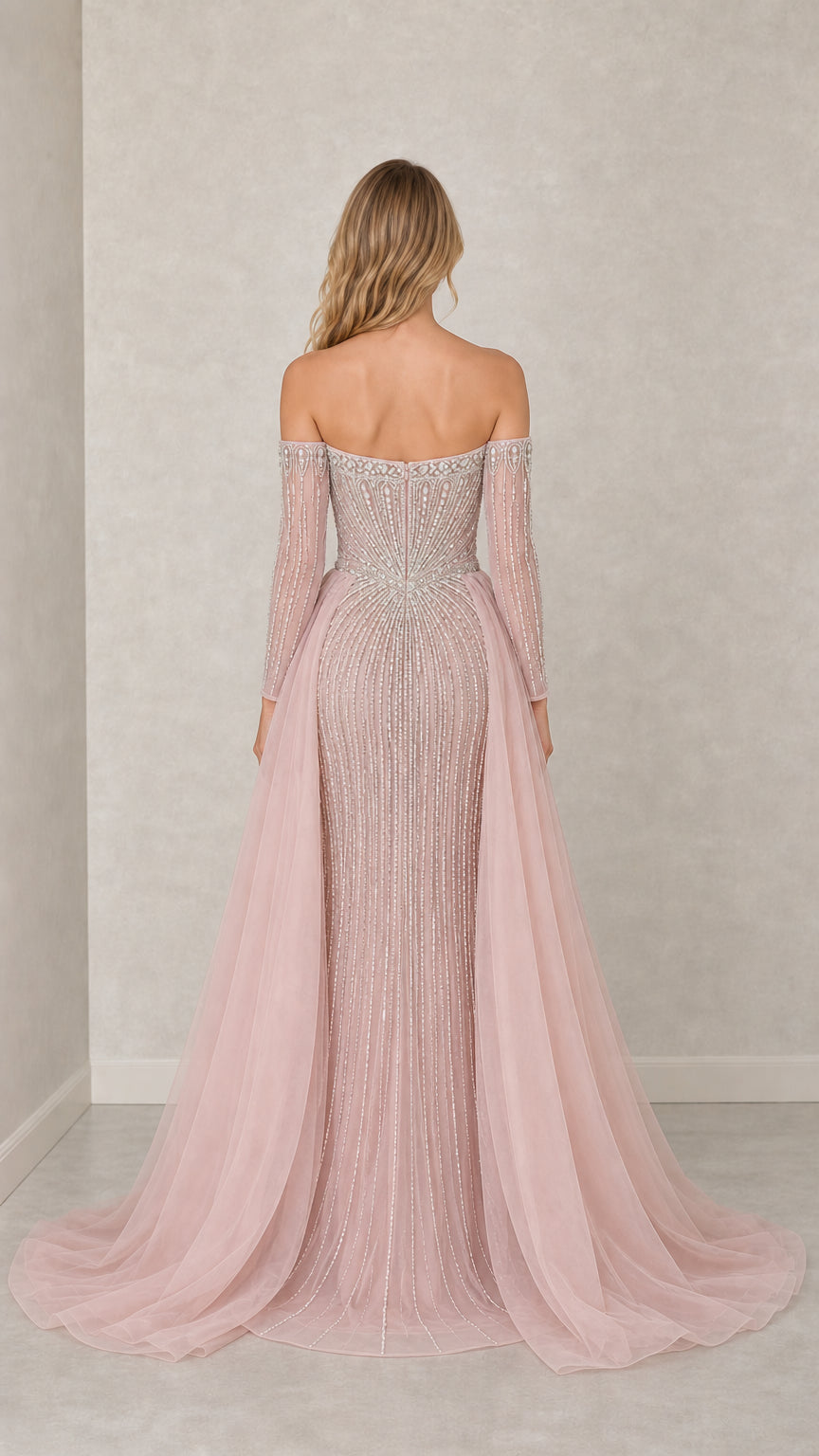 Back view showing sweeping train on dusty pink formal gown