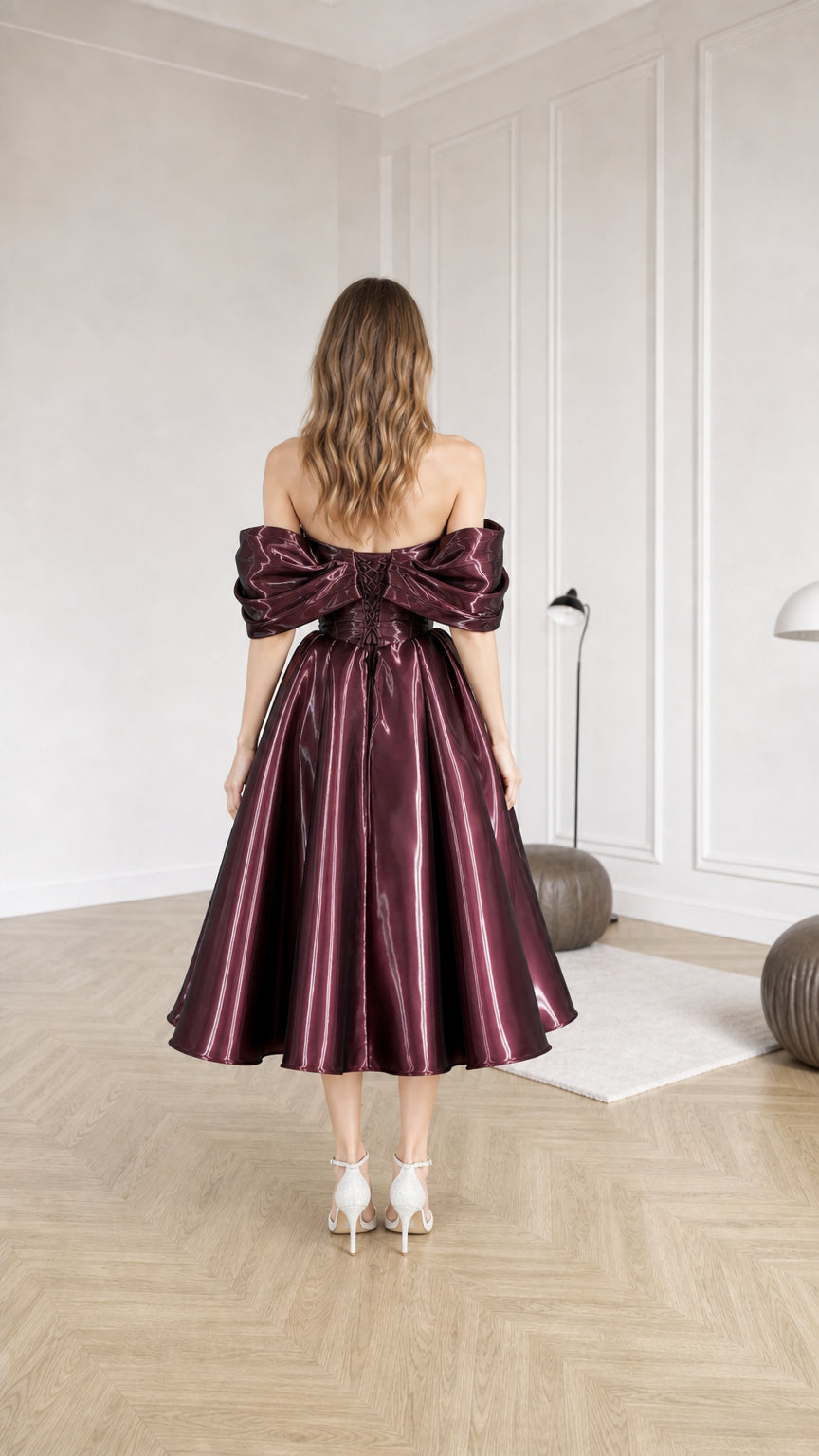 Back view of burgundy metallic dress with voluminous back detail