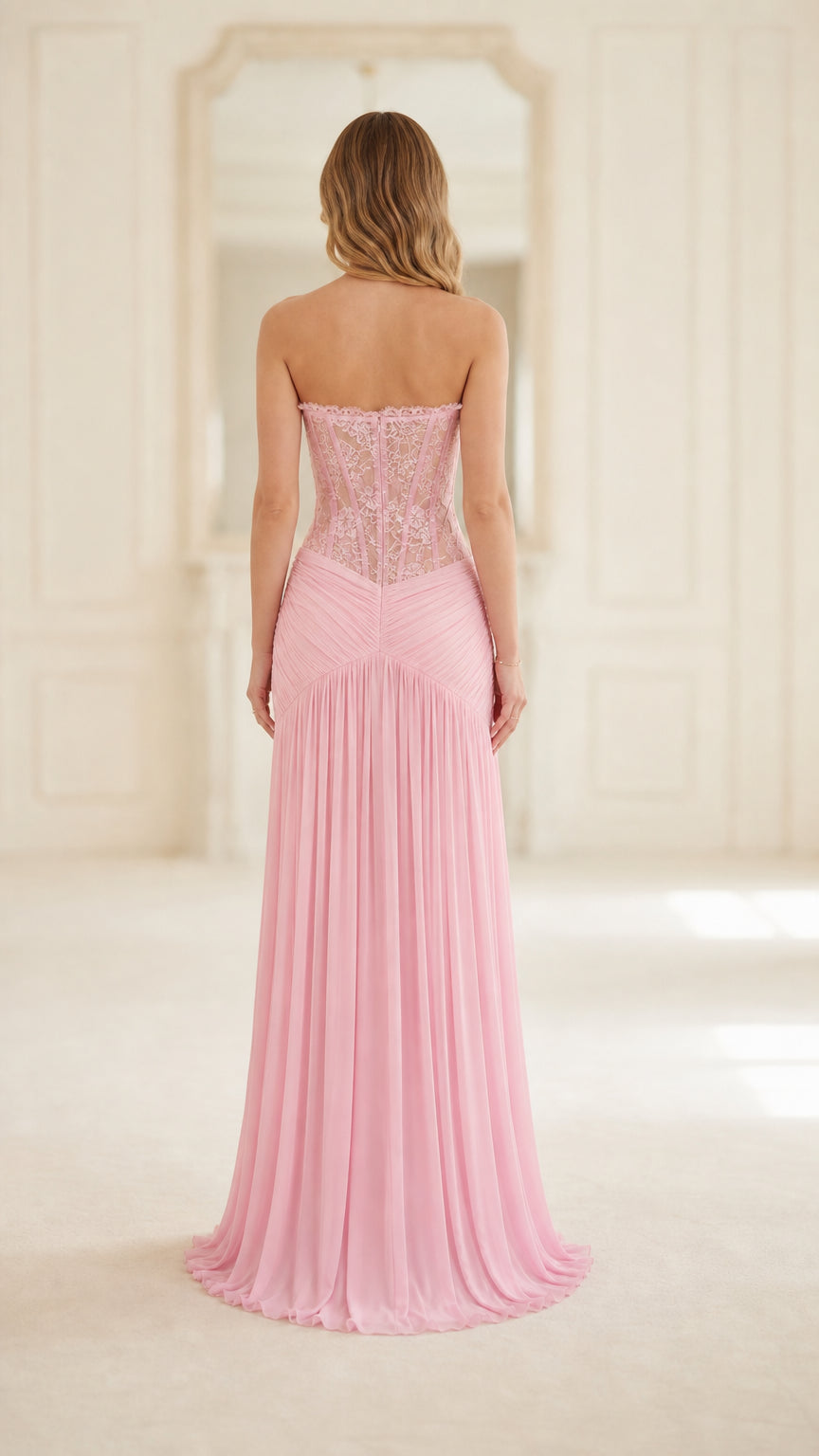 Back view of model in pink strapless lace corset formal dress