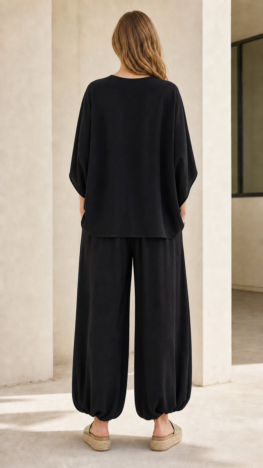 Back view of woman wearing black two-piece lounge outfit