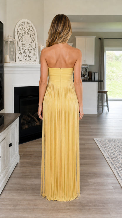 Back view of yellow strapless fringe maxi dress