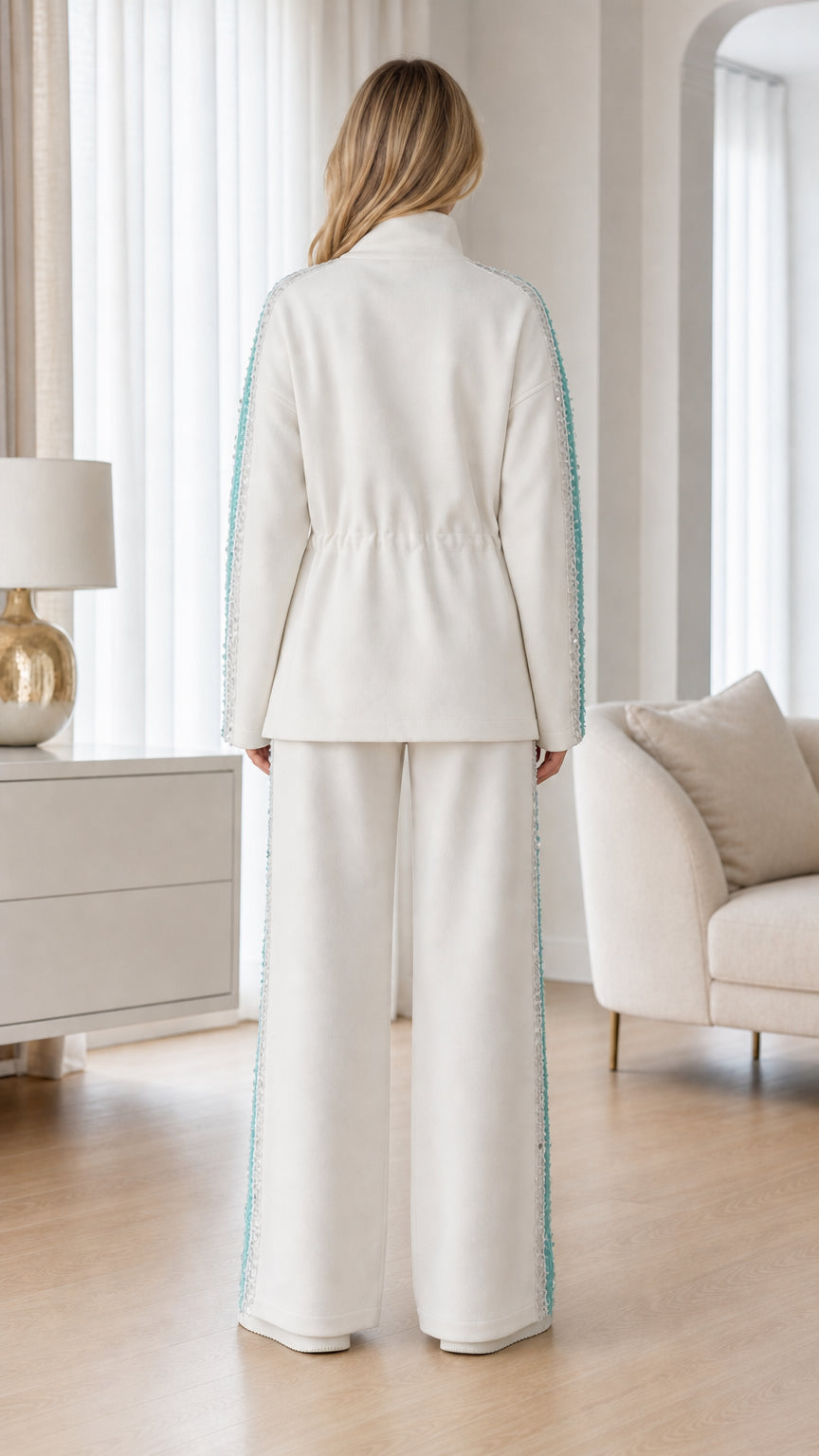 Back view of woman wearing white zip-up jacket and wide-leg sweatpants