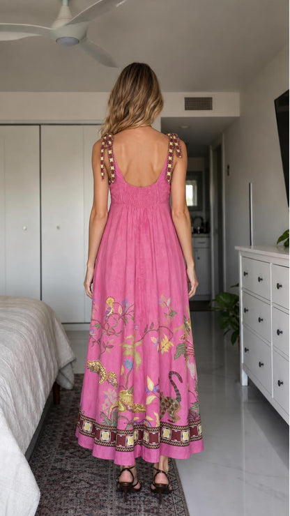 Woman wearing pink boho floral embroidered maxi dress, back view