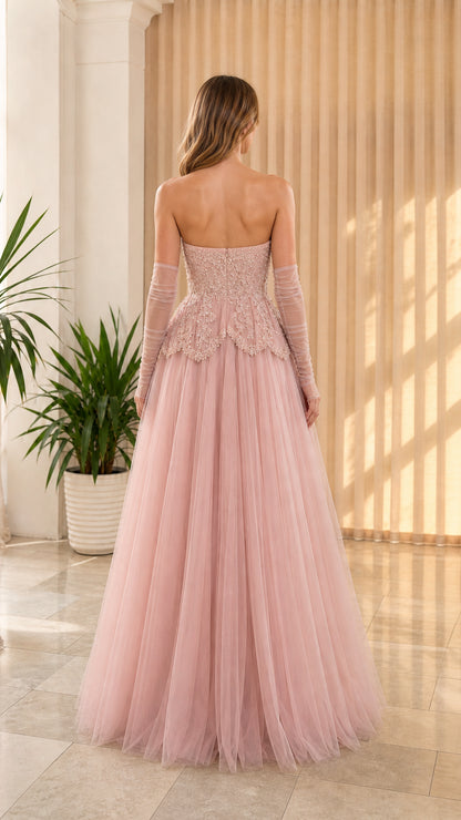 Back view of dusty pink strapless formal evening dress showcasing fitted corset back and tulle skirt