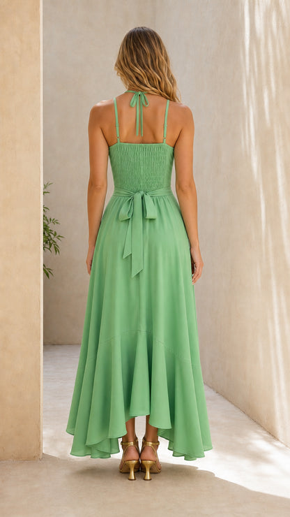Back view of sage green maxi dress showing smocked bodice and self-tie bow