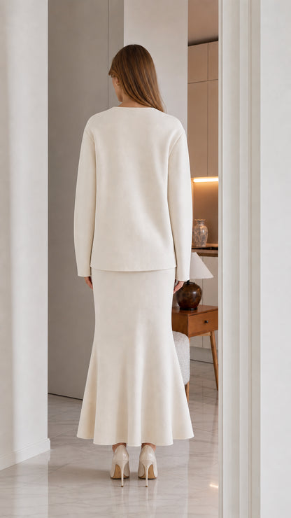 Back view of model wearing cream knit cardigan and mermaid skirt set