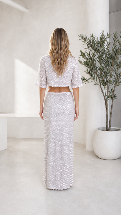 Back view of model in silver sequin crop top and maxi skirt