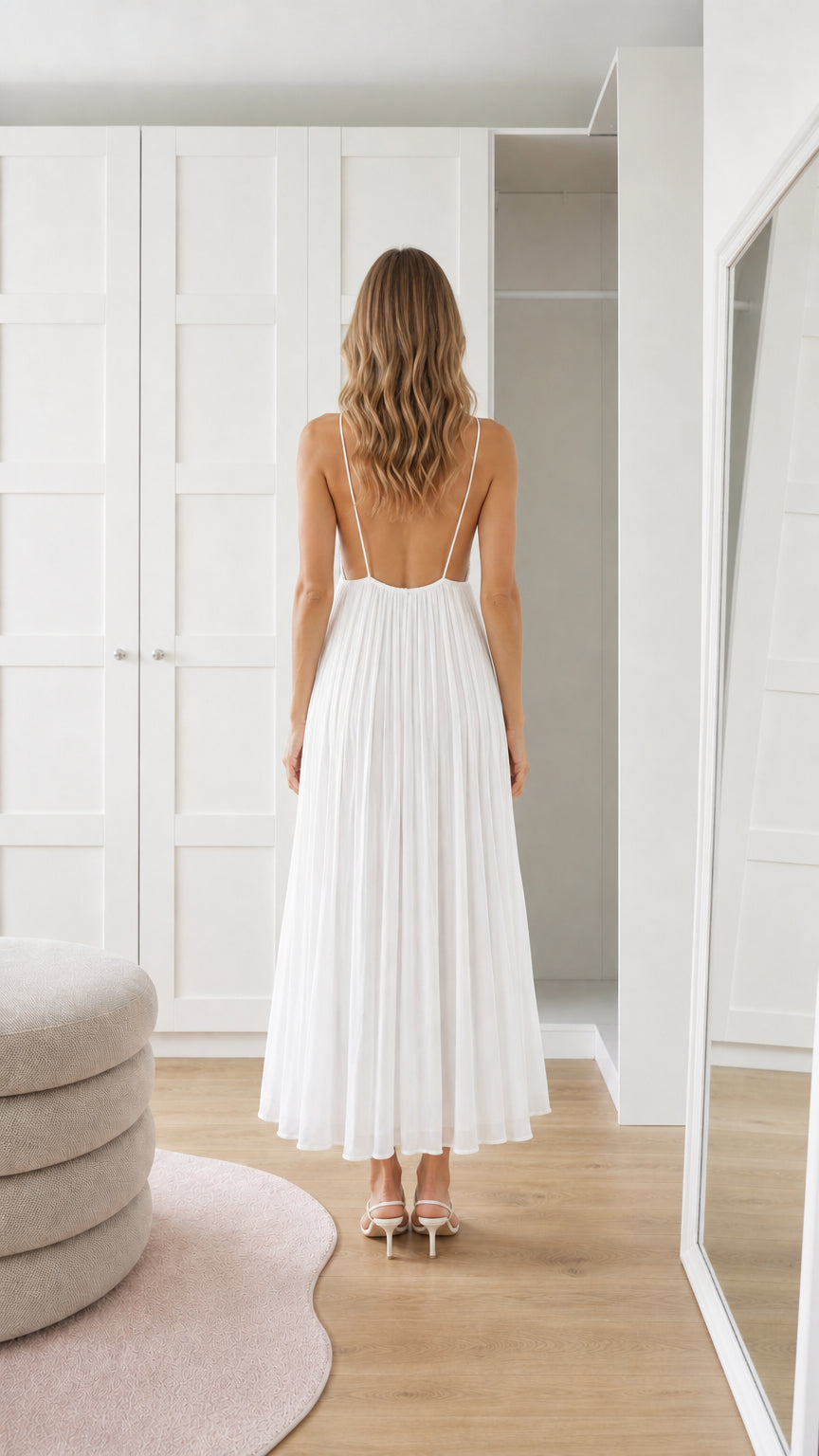 Back view of white sequin pleated maxi dress showing open back